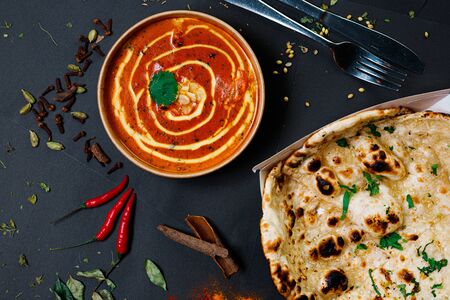 Indian food on a dark background, in paper utensils, photos for menus and advertising. Additives and spicy spices.の写真素材