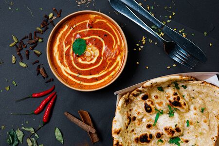 Indian food on a dark background, in paper utensils, photos for menus and advertising. Additives and spicy spices.の写真素材