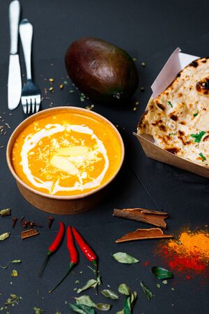 Indian food on a dark background, in paper utensils, photos for menus and advertising. Additives and spicy spices.の写真素材