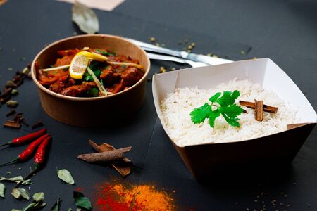Indian food on a dark background, in paper utensils, photos for menus and advertising. Additives and spicy spices.の写真素材
