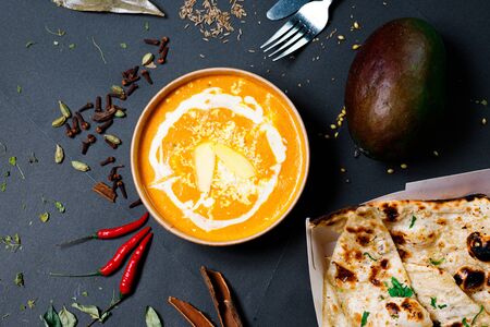 Indian food on a dark background, in paper utensils, photos for menus and advertising. Additives and spicy spices.の写真素材