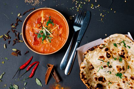 Indian food on a dark background, in paper utensils, photos for menus and advertising. Additives and spicy spices.の写真素材