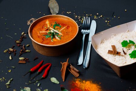 Indian food on a dark background, in paper utensils, photos for menus and advertising. Additives and spicy spices.の写真素材