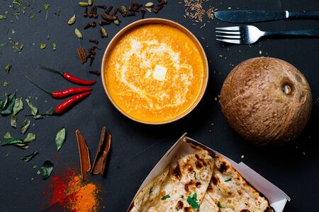 Indian food on a dark background, in paper utensils, photos for menus and advertising. Additives and spicy spices.の写真素材