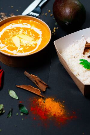 Indian food on a dark background, in paper utensils, photos for menus and advertising. Additives and spicy spices.の写真素材