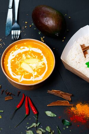 Indian food on a dark background, in paper utensils, photos for menus and advertising. Additives and spicy spices.の写真素材
