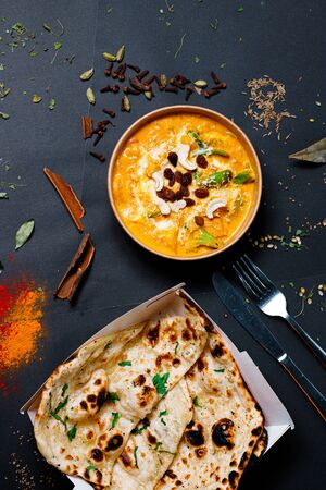 Indian food on a dark background, in paper utensils, photos for menus and advertising. Additives and spicy spices.の写真素材