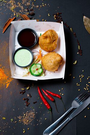 Indian food on a dark background, in paper utensils, photos for menus and advertising. Additives and spicy spices.の写真素材