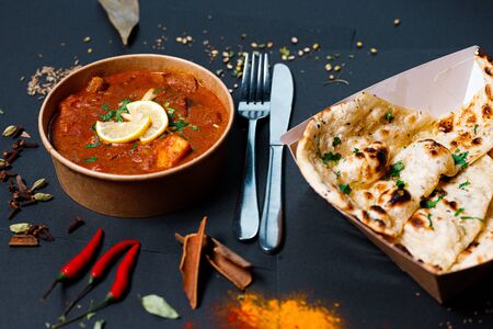Indian food on a dark background, in paper utensils, photos for menus and advertising. Additives and spicy spices.の写真素材