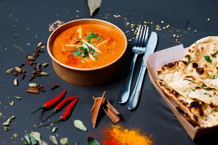 Indian food on a dark background, in paper utensils, photos for menus and advertising. Additives and spicy spices.の写真素材