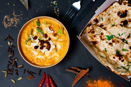 Indian food on a dark background, in paper utensils, photos for menus and advertising. Additives and spicy spices.の写真素材