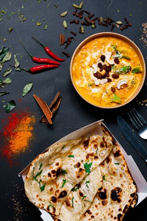 Indian food on a dark background, in paper utensils, photos for menus and advertising. Additives and spicy spices.の写真素材