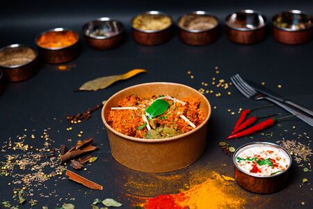 Indian food on a dark background, in paper utensils, photos for menus and advertising. Additives and spicy spices.の写真素材
