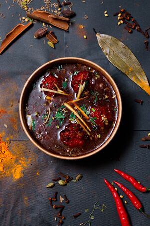 Indian food on a dark background, in paper utensils, photos for menus and advertising. Additives and spicy spices.の写真素材