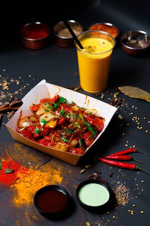 Indian food on a dark background, in paper utensils, photos for menus and advertising. Additives and spicy spices.の写真素材