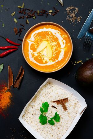 Indian food on a dark background, in paper utensils, photos for menus and advertising. Additives and spicy spices.の写真素材