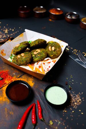 Indian food on a dark background, in paper utensils, photos for menus and advertising. Additives and spicy spices.の写真素材