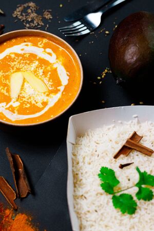 Indian food on a dark background, in paper utensils, photos for menus and advertising. Additives and spicy spices.の写真素材