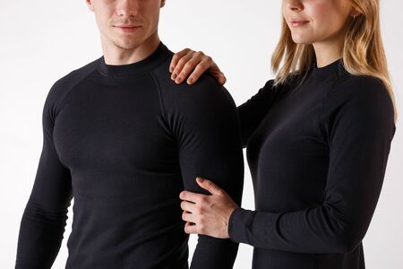 Guy and girl in thermal underwear on a white backgroundの写真素材