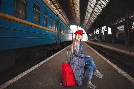 Lady in a red cap and with a red bag, urban geometry.の写真素材