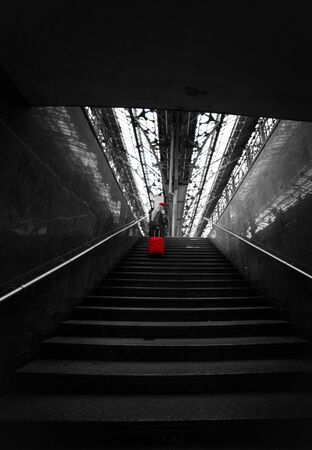 Railway station. Beautiful girl climbs the stairs. Lady in a red cap.の写真素材