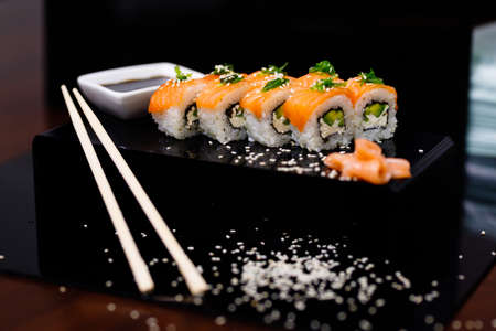 Sushi with salmon. Soy sauce, ginger, red caviar. Roles with red fish.の写真素材