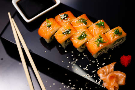 Sushi with salmon. Soy sauce, ginger, red caviar. Roles with red fish.の写真素材