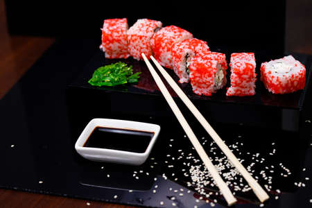 Sushi with salmon. Soy sauce, red caviar. Sushi on a black background.の写真素材