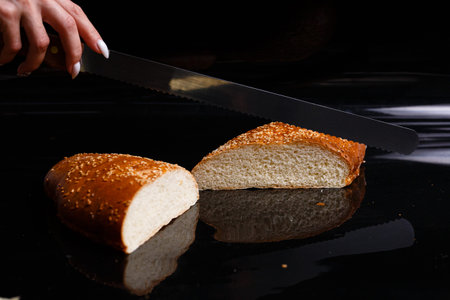Homemade pastries. Crispy white bread cut with a knife.