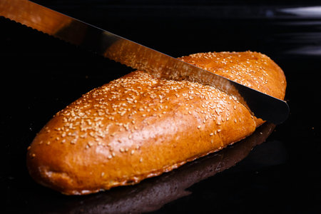 Homemade pastries. Crispy white bread cut with a knife.