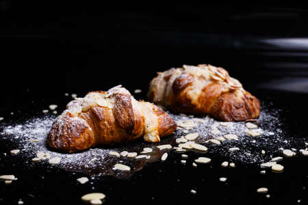 Croissants with chocolate. Homemade pastries, croissants sprinkled with powder and cereals.の写真素材