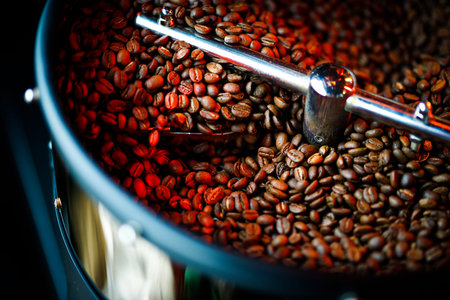 Coffee beans in a coffee machine, in dark colors.