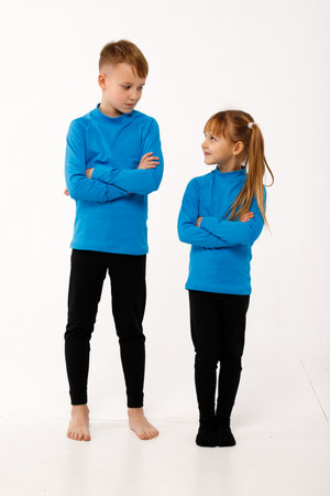 A little girl and her older brother in thermal clothes.の写真素材