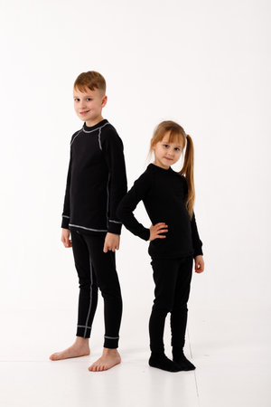 A little girl and her older brother in thermal clothes.の写真素材