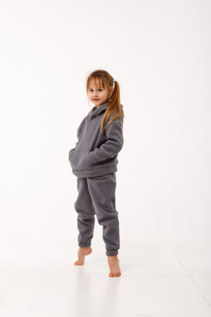 Little girl in thermal clothes, on a white background.の写真素材