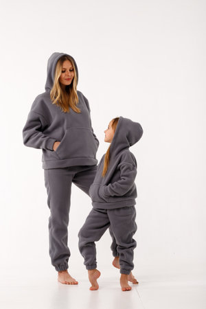 Sporty mom and her little daughter in thermal clothes.の写真素材