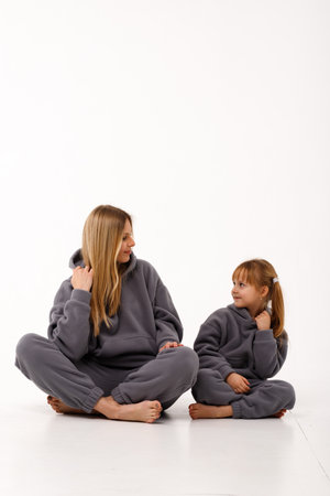 Sporty mom and her little daughter in thermal clothes.の写真素材