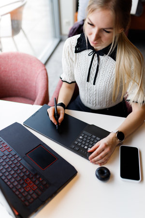 The girl works and studies with a graphic tabletの写真素材