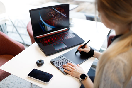 The girl works and studies with a graphic tabletの写真素材
