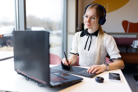 The girl works and studies with a graphic tabletの写真素材