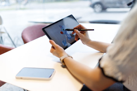 The girl works and studies with a graphic tabletの写真素材