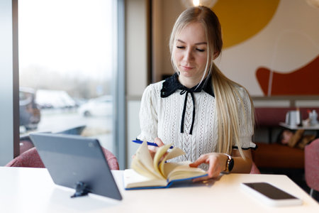 Businesswoman Yulia works remotely in a cafeの写真素材