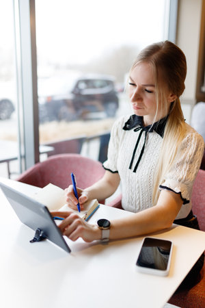 Businesswoman Yulia works remotely in a cafeの写真素材