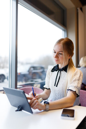 Businesswoman Yulia works remotely in a cafeの写真素材