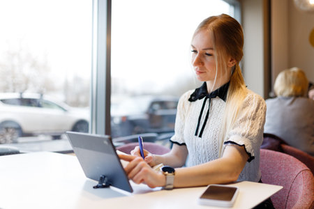 Businesswoman Yulia works remotely in a cafeの写真素材