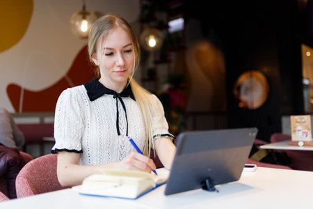 Businesswoman Yulia works remotely in a cafeの写真素材
