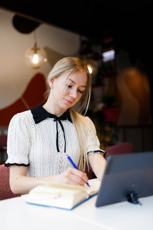 Businesswoman Yulia works remotely in a cafeの写真素材