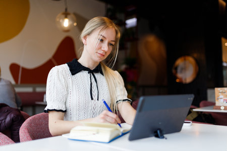 Businesswoman Yulia works remotely in a cafeの写真素材