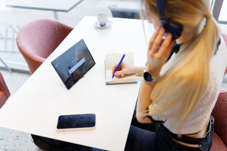 Businesswoman Yulia works remotely in a cafeの写真素材