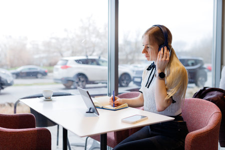 Businesswoman Yulia works remotely in a cafeの写真素材